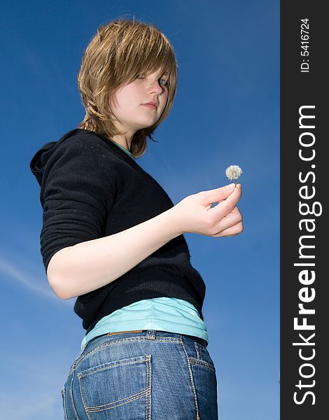 The young attractive girl with a dandelion. The young attractive girl with a dandelion