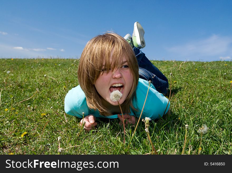 The young girl laying on a green grass