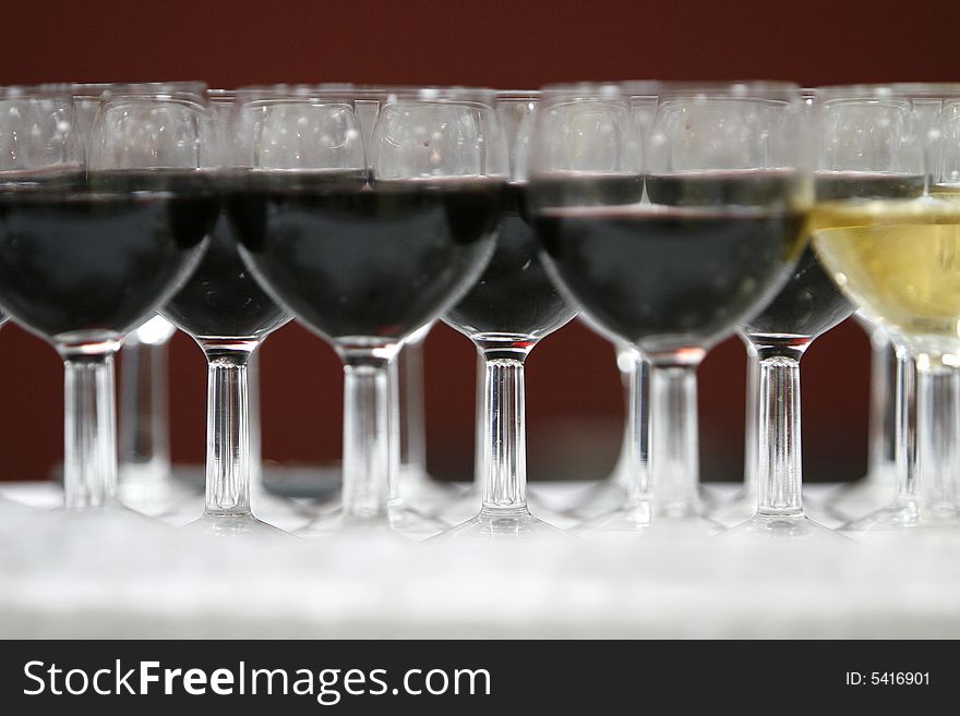 A part with  black and white glasses of wine. A part with  black and white glasses of wine