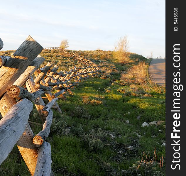 Split rail fence leads the way into a mountain top sunrise. Split rail fence leads the way into a mountain top sunrise.