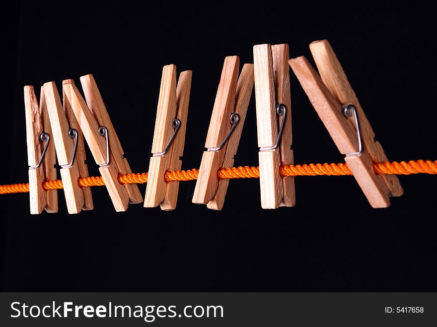 Wooden clips on a orange rope