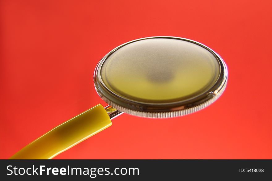 Yellow stethoscope in red background