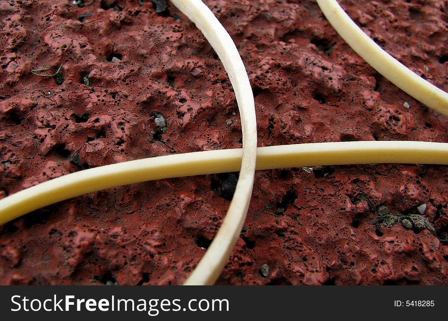 Close-up of white rubber line on red background