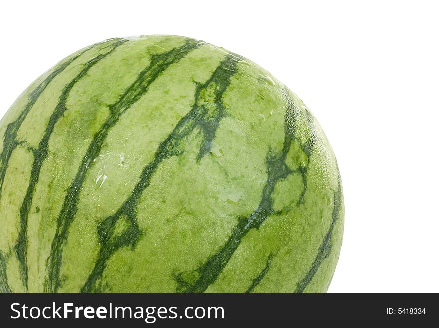 A fresh personal size watermelon with droplets of cool water. A fresh personal size watermelon with droplets of cool water