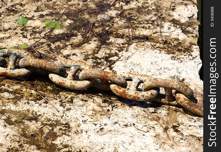 An old oxidized chain in a fountain. An old oxidized chain in a fountain