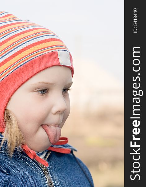 A young girl putting her tongue out