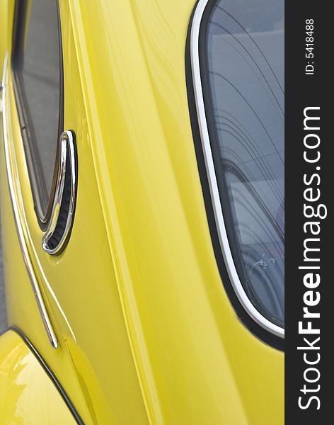 A detail image of a yellow vintage German car