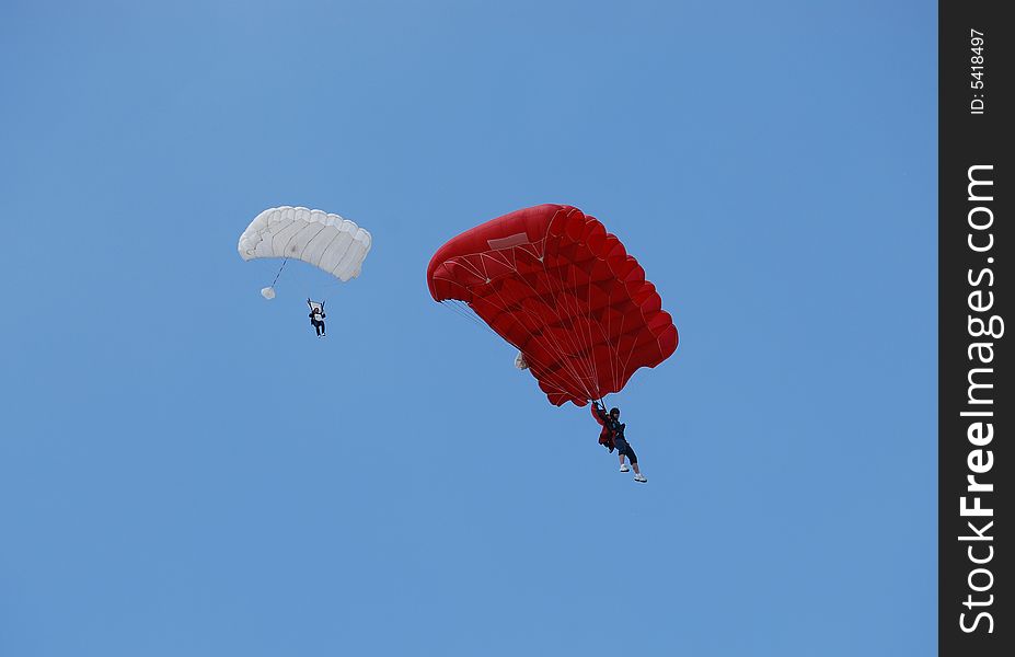 Two parachuters on the blue sky. Two parachuters on the blue sky