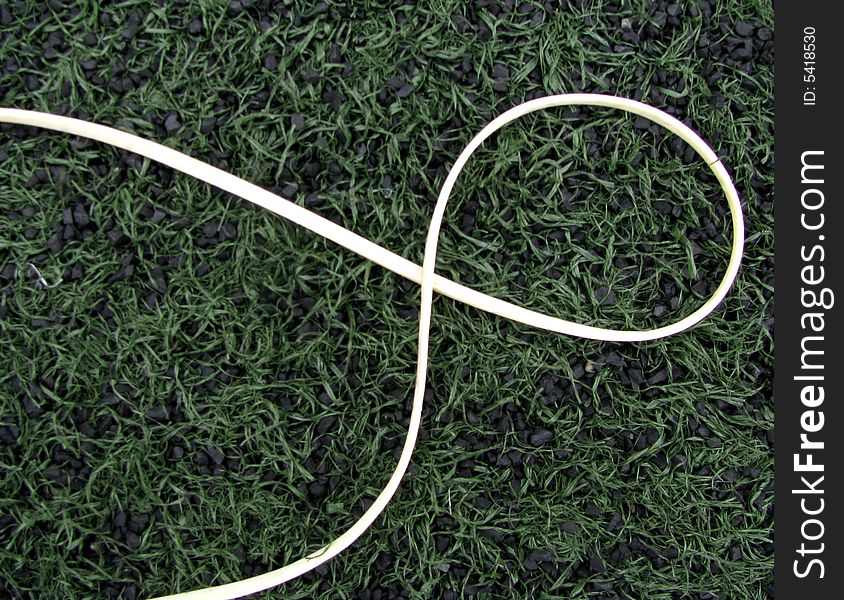 Close-up of white rubber line on green background