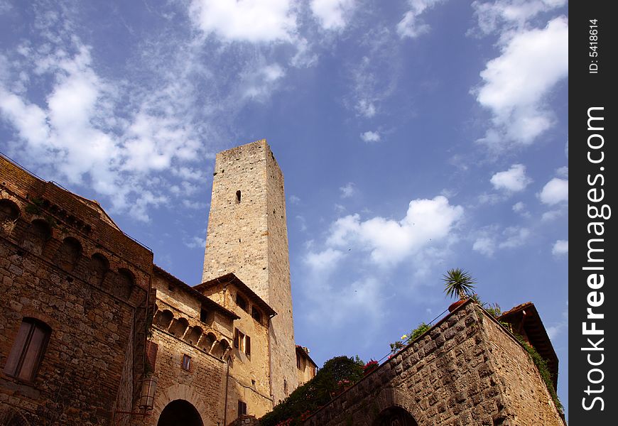One of the famous tower on San Gimignano under a cloudy sky -Siena. One of the famous tower on San Gimignano under a cloudy sky -Siena