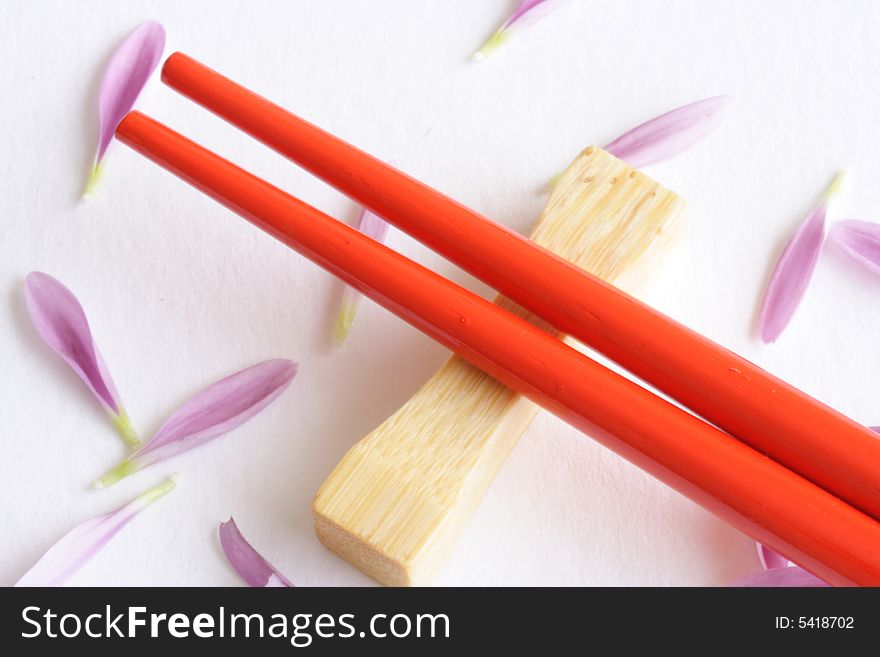 Close up of red sticks with petals