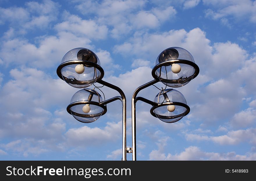 Street lamps with cloudy sky behind. Street lamps with cloudy sky behind