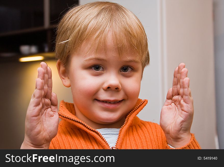 A caucasian boy with blonde hair  showing size of some object. A caucasian boy with blonde hair  showing size of some object