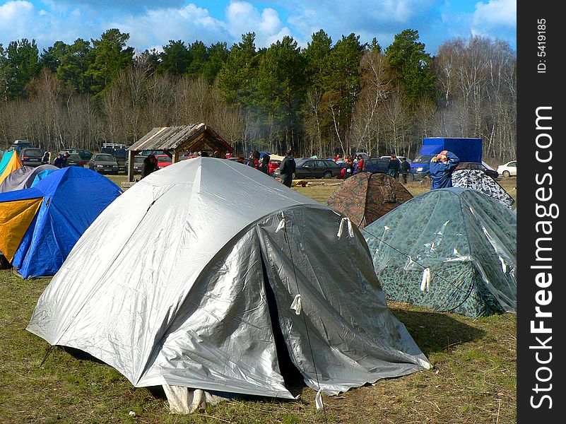 Bright tent in the forrest on the grass