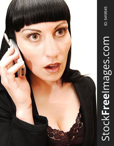 An serous looking businesswoman in a black suit and strait hair talking on 
her cell phone. An serous looking businesswoman in a black suit and strait hair talking on 
her cell phone.
