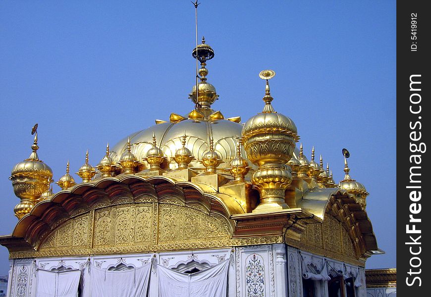A Golden plated dome of the golden temple in India. A Golden plated dome of the golden temple in India