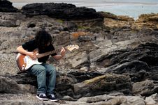 Teenage Guitar Player On Beach Royalty Free Stock Photo