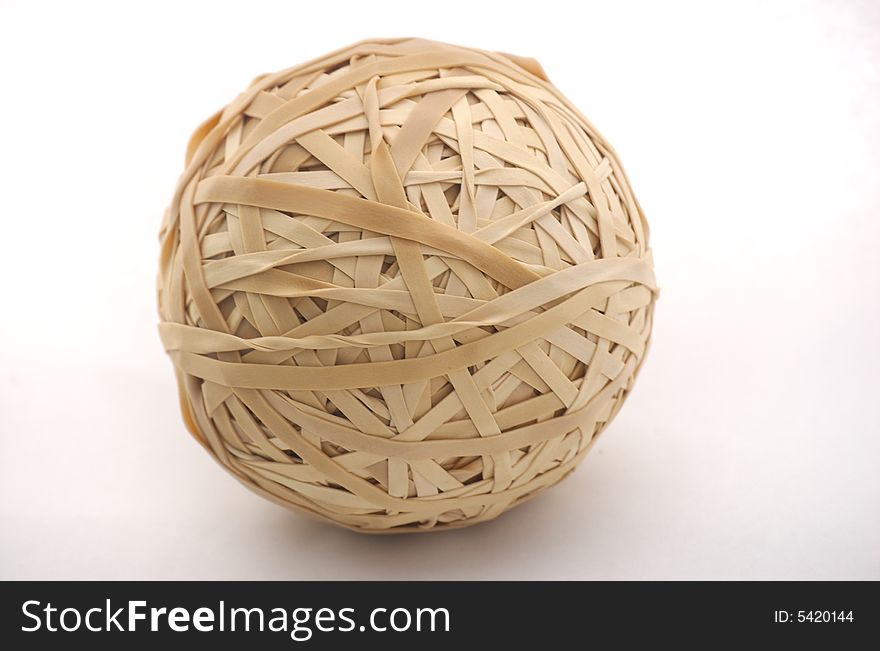A photograph of a rubber band ball isolated against a white background