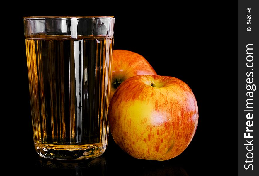 Apples and juice isolated on black background