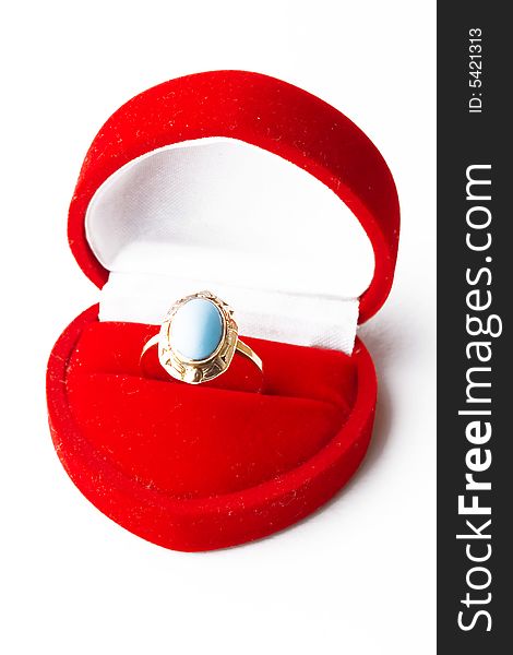 Golden ring with blue precious stone