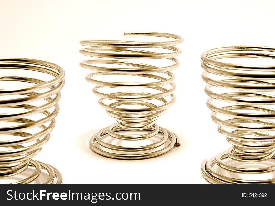 THree egg cups, placed over white background. THree egg cups, placed over white background