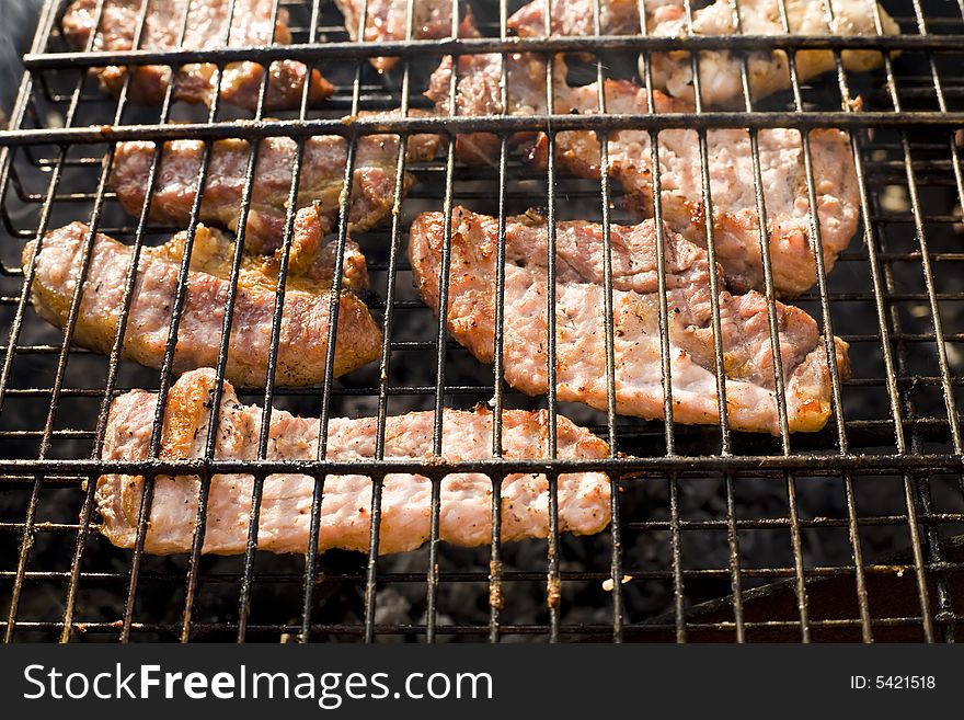 Meat cooking on barbeque grill with flames. Meat cooking on barbeque grill with flames