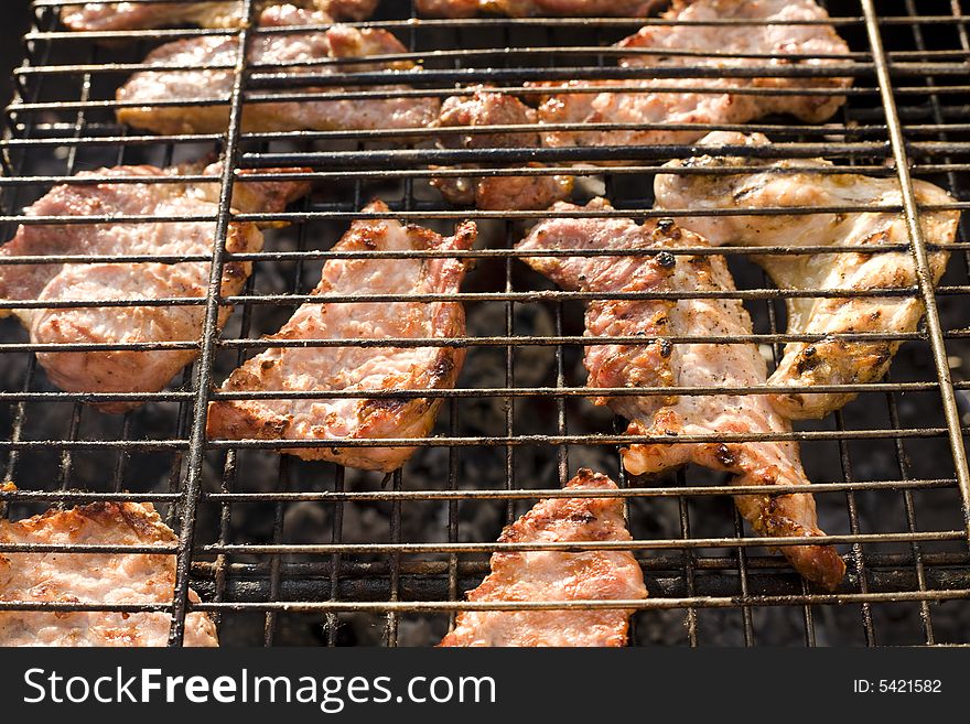 Meat cooking on barbeque grill with flames. Meat cooking on barbeque grill with flames