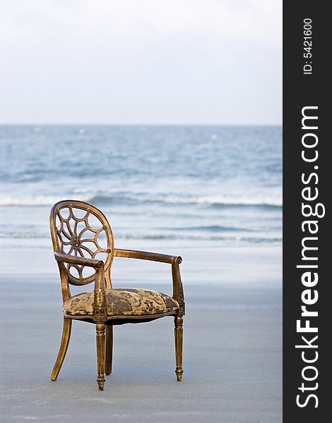 Ornate french chair on ocean beach. Ornate french chair on ocean beach