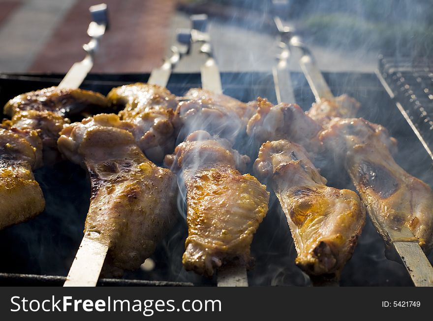 Chicken cooking on barbeque grill with flames. Chicken cooking on barbeque grill with flames