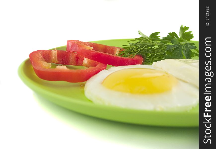 Colourful sunny-side up eggs on white