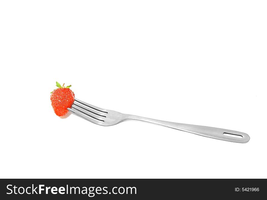 Fork with strawberry over white