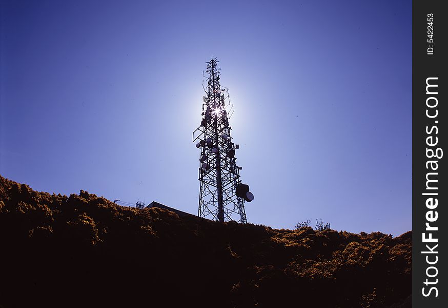 Large telecommunications mast backlit by sun. Large telecommunications mast backlit by sun