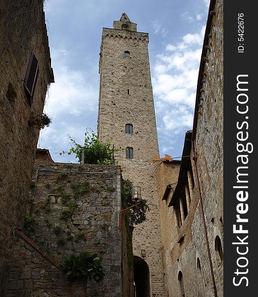 An original shot of the majestic bell's tower of the Cathedral in San Gimignano - Siena