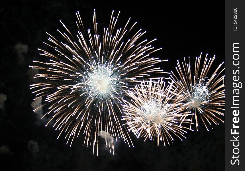 Fireworks exploding three white spheres. Fireworks exploding three white spheres