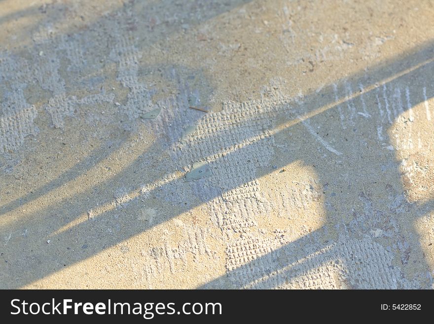 Shadows make an attractive design background on an old cement surface. Shadows make an attractive design background on an old cement surface.