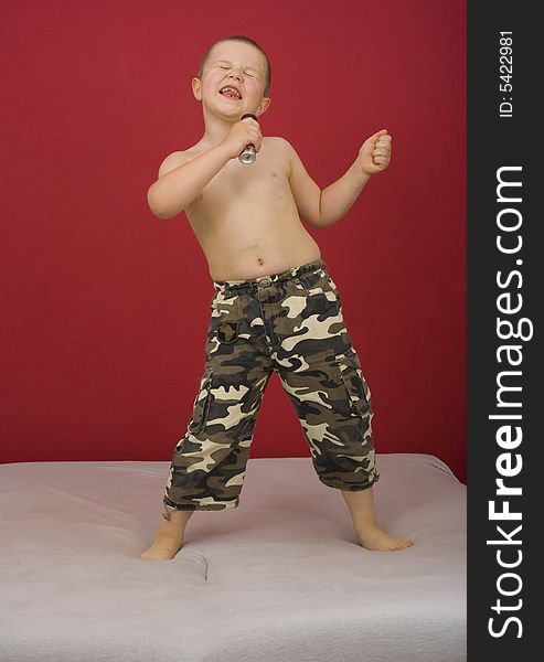 Boy sings, boy in military trousers, party
