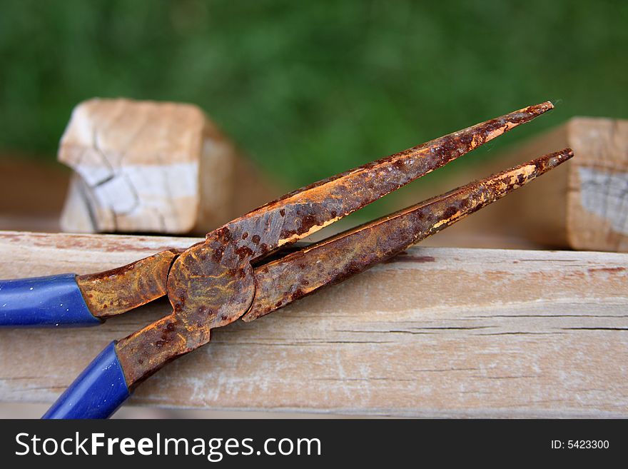 Rusty pliers on wooden deck