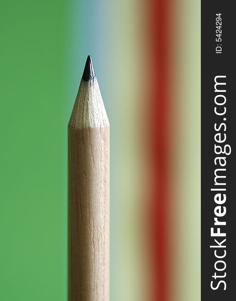 A pencil  with a simple  colorful background. A pencil  with a simple  colorful background