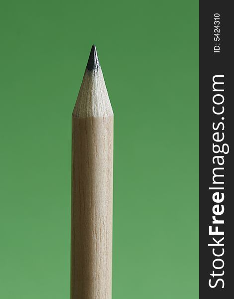 A pencil  with a simple green color background. A pencil  with a simple green color background