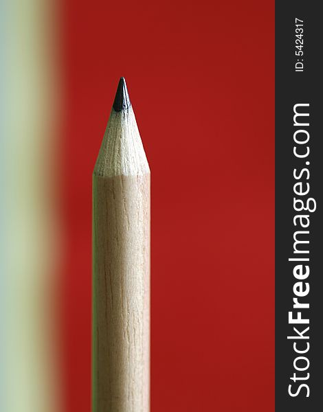 A pencil  with a simple yellow red color background. A pencil  with a simple yellow red color background