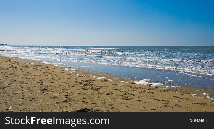 Wave breaking on the beach. Clear sky. Wave breaking on the beach. Clear sky.