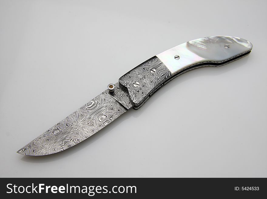 Stainless steel pocket knife isolated on the white background