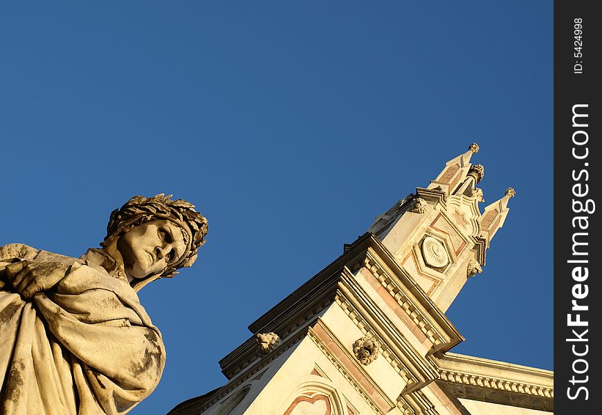 A wonderfull shot of the statue of Dante Alighieri and a glimpse of Santa Croce church in Florence - Italy. A wonderfull shot of the statue of Dante Alighieri and a glimpse of Santa Croce church in Florence - Italy