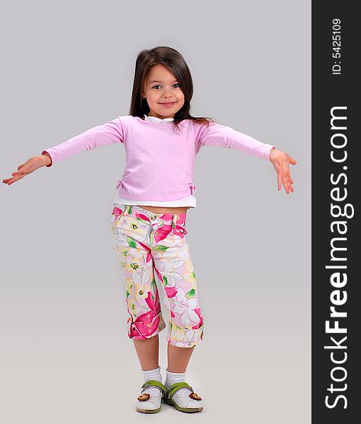 Cute smiling baby girl posing in brightly colored clothes. Cute smiling baby girl posing in brightly colored clothes