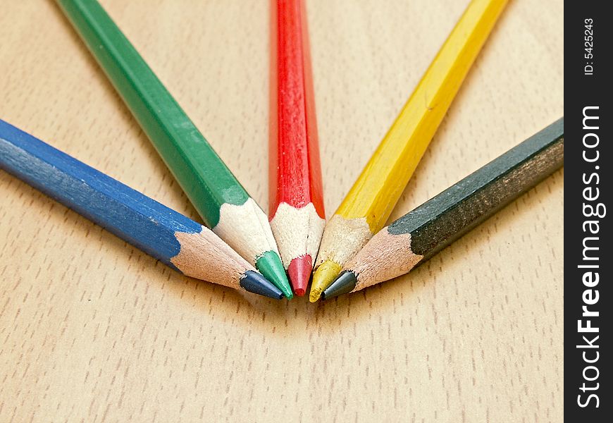 Color pencils lay on a table. The photo is made with small depth of sharpness, camera Konica Minolta Dimage Z5.