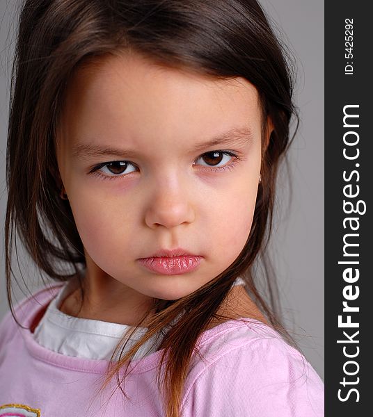Portrait of little cute girl with brown hair expressing sadness. Portrait of little cute girl with brown hair expressing sadness