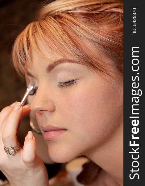 A bride getting her makeup done. A bride getting her makeup done