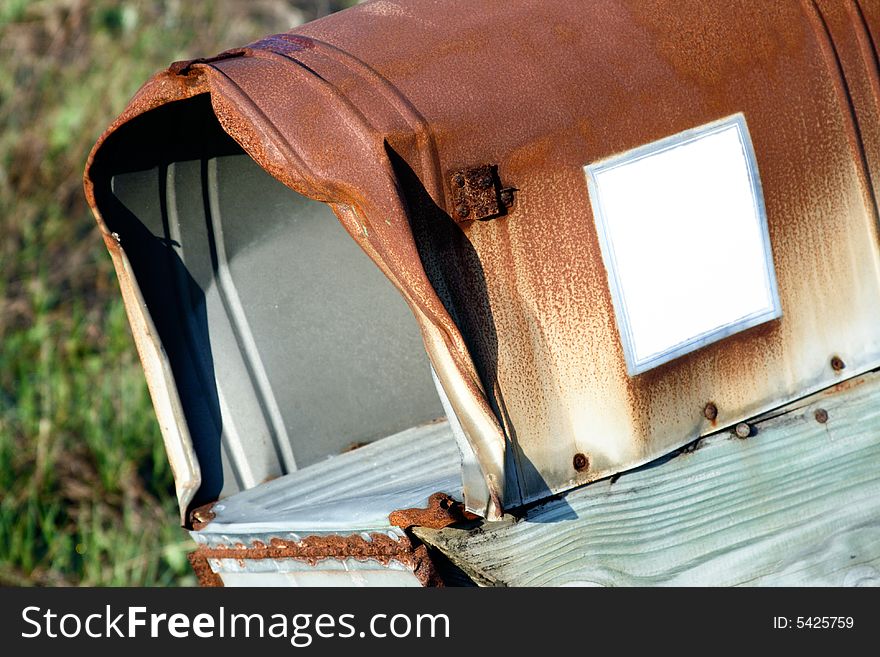 Rusty old and twisted mailbox with white square for type. Rusty old and twisted mailbox with white square for type.