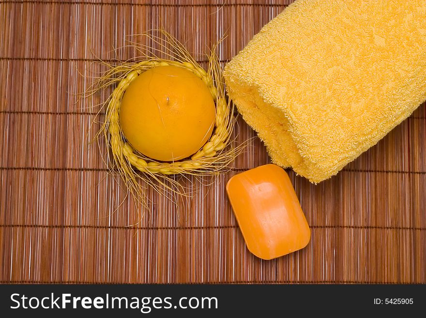 Spa scenery - yellow towel, soap and candle