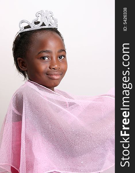 Young girl wearing a pink fairy costume with accessories